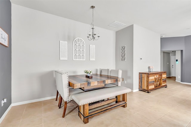 dining space with a chandelier, light tile patterned flooring, and baseboards
