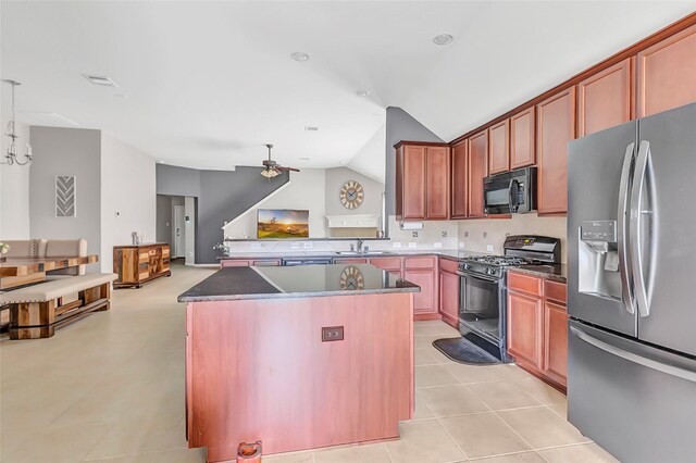 kitchen featuring black appliances, lofted ceiling, a center island, ceiling fan, and a sink