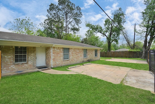 back of property featuring brick siding, a patio, and a shingled roof