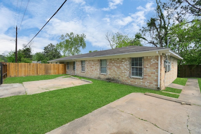 view of front of property with a patio and brick siding