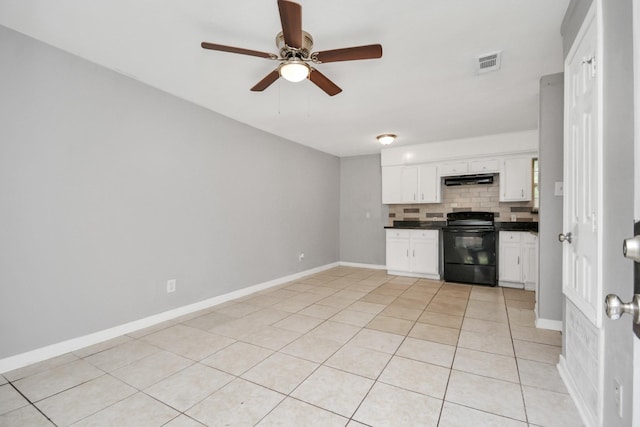 kitchen with black range with electric cooktop, dark countertops, decorative backsplash, ceiling fan, and white cabinetry