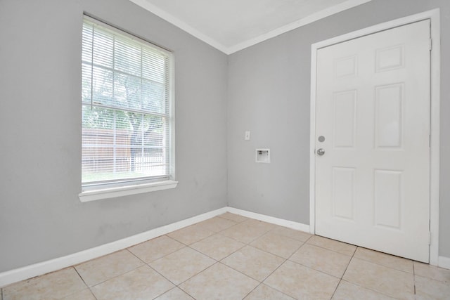 empty room featuring crown molding, baseboards, and light tile patterned flooring