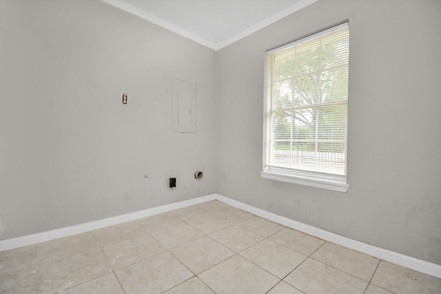 empty room with ornamental molding, baseboards, and light tile patterned flooring