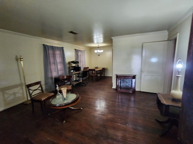 sitting room with crown molding, wood finished floors, and a chandelier
