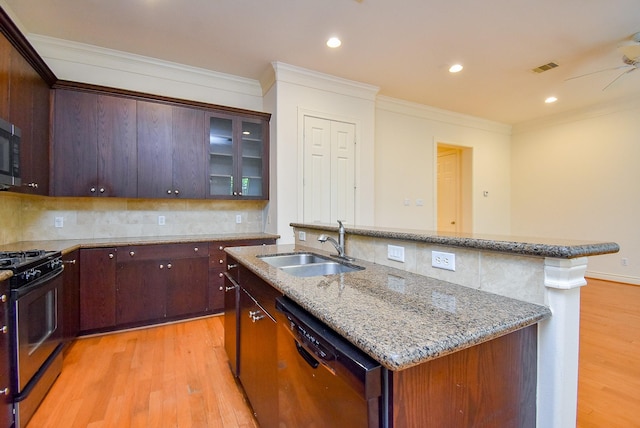 2612 Starboard Point Dr, Houston, TX 77054 - kitchen featuring stainless steel gas stove, dishwasher, a sink, light wood-style flooring, and decorative backsplash
