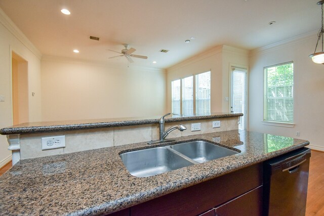 2612 Starboard Point Dr, Houston, TX 77054 - kitchen featuring dishwashing machine, a sink, crown molding, wood finished floors, and light stone counters