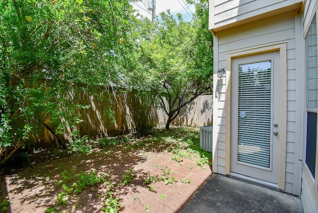 2612 Starboard Point Dr, Houston, TX 77054 - view of exterior entry with fence, central AC unit, and a patio