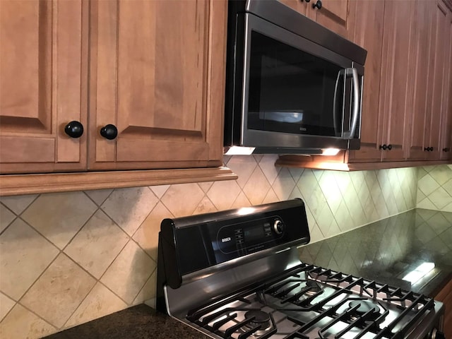 1428 Wichita St, Houston, TX 77004 - kitchen with gas range oven, backsplash, and dark countertops
