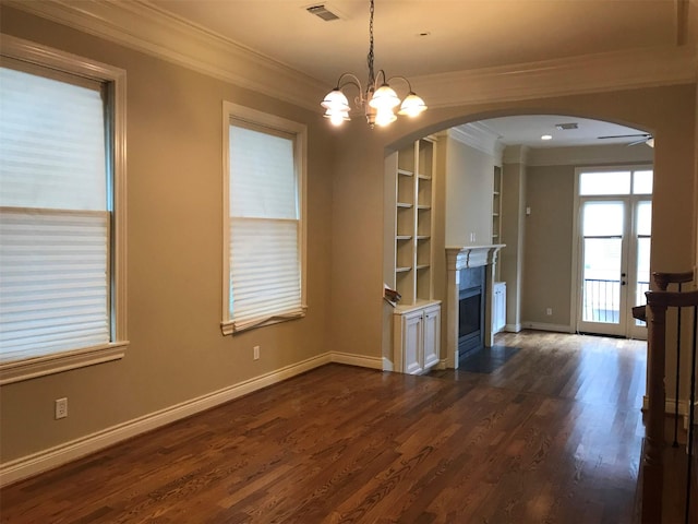 1428 Wichita St, Houston, TX 77004 - empty room featuring arched walkways, ornamental molding, dark wood-style flooring, a fireplace with flush hearth, and baseboards