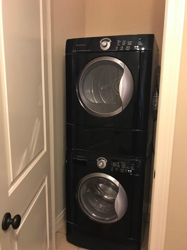 1428 Wichita St, Houston, TX 77004 - laundry area with stacked washer and clothes dryer, baseboards, and tile patterned floors