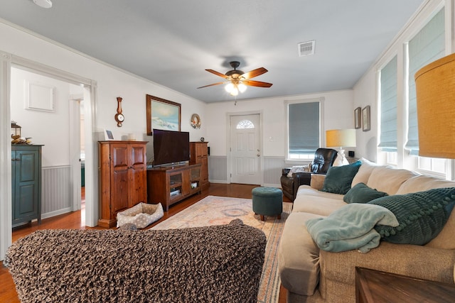 2120 73rd St, Galveston, TX 77551 - living room with wood finished floors, a wainscoted wall, and ceiling fan