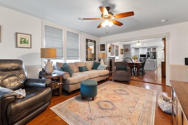 2120 73rd St, Galveston, TX 77551 - living room with wainscoting, ceiling fan, and wood finished floors