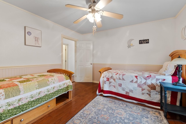 2120 73rd St, Galveston, TX 77551 - bedroom featuring wood finished floors, a wainscoted wall, crown molding, and a ceiling fan