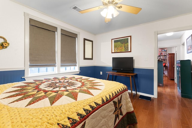 2120 73rd St, Galveston, TX 77551 - bedroom featuring wainscoting, wood-type flooring, and ceiling fan