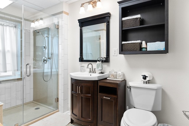 2120 73rd St, Galveston, TX 77551 - full bathroom featuring a stall shower, vanity, toilet, and healthy amount of natural light