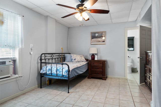 2120 73rd St, Galveston, TX 77551 - bedroom with a paneled ceiling, light tile patterned floors, connected bathroom, baseboards, and a ceiling fan