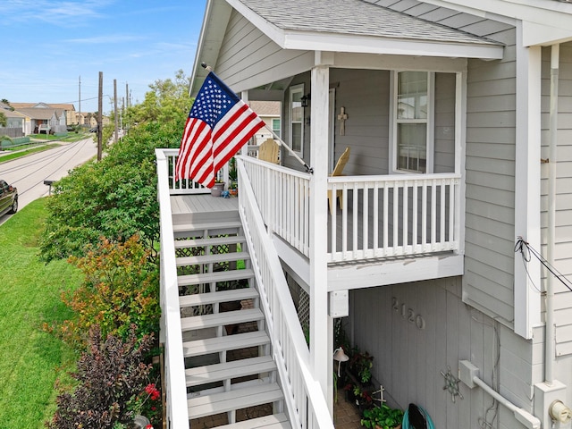 2120 73rd St, Galveston, TX 77551 - view of home's exterior featuring stairway and a shingled roof