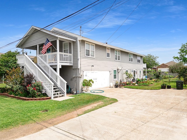 2120 73rd St, Galveston, TX 77551 - view of front of home with an attached garage, a porch, a front yard, stairway, and concrete driveway