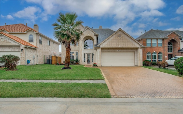 11939 Galentine Pt, Cypress, TX 77429 - view of front of home featuring an attached garage, decorative driveway, brick siding, and a gate