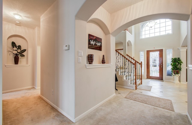 11939 Galentine Pt, Cypress, TX 77429 - entryway with carpet, stairway, arched walkways, and baseboards