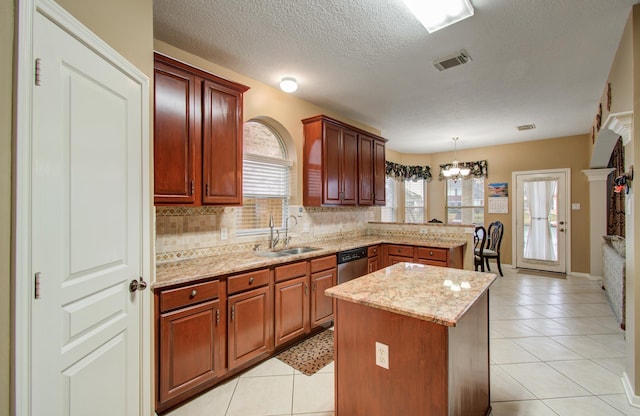 11939 Galentine Pt, Cypress, TX 77429 - kitchen featuring a sink, a peninsula, light tile patterned floors, decorative backsplash, and a center island
