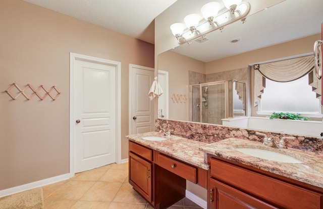 11939 Galentine Pt, Cypress, TX 77429 - full bath with a stall shower, double vanity, tile patterned flooring, and baseboards