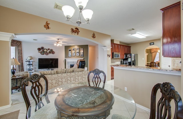 11939 Galentine Pt, Cypress, TX 77429 - dining room featuring arched walkways, light tile patterned floors, and a ceiling fan
