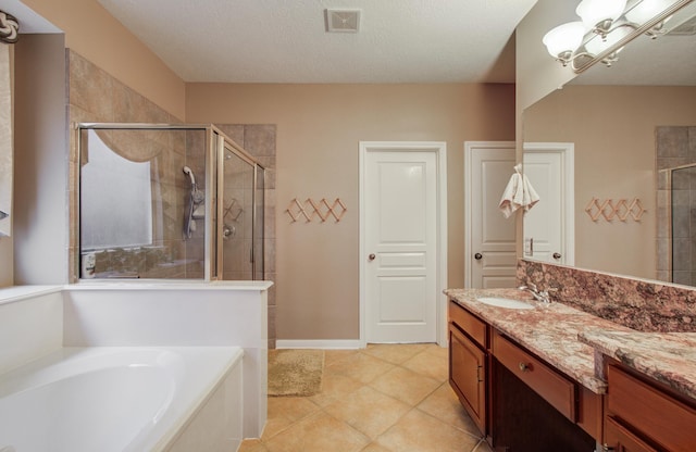 11939 Galentine Pt, Cypress, TX 77429 - full bathroom featuring a shower stall, a garden tub, vanity, tile patterned floors, and a textured ceiling