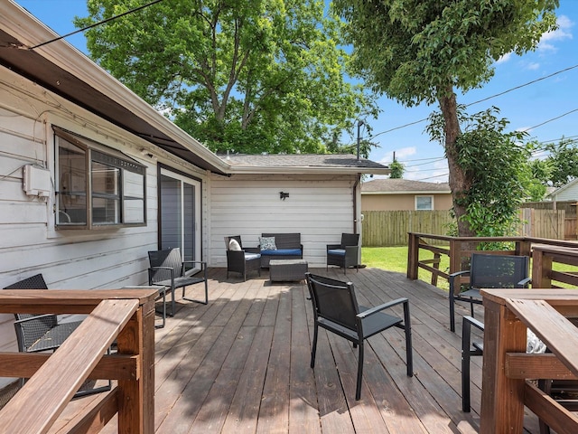 wooden terrace featuring outdoor lounge area and fence