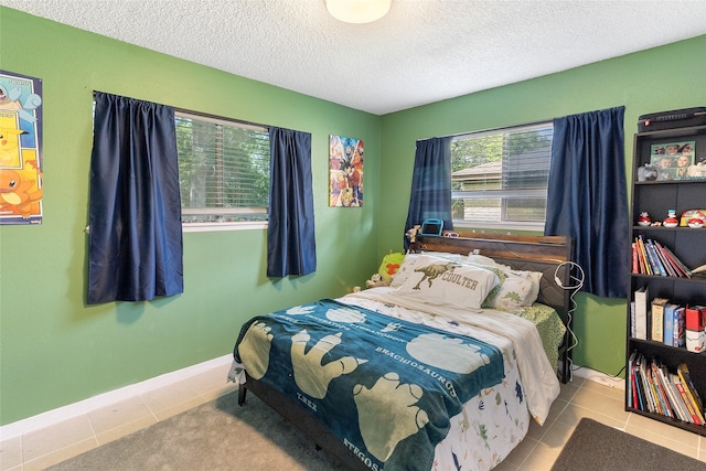 1448 Camellia Dr, Sweeny, TX 77480 - tiled bedroom with a textured ceiling and baseboards