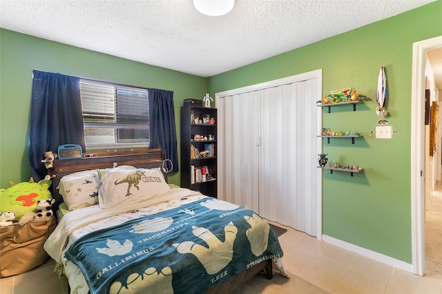 1448 Camellia Dr, Sweeny, TX 77480 - tiled bedroom with a textured ceiling and baseboards