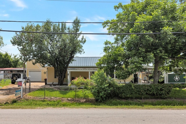 639 Manor St, Houston, TX 77015 - view of property hidden behind natural elements featuring a fenced front yard, metal roof, and an attached garage