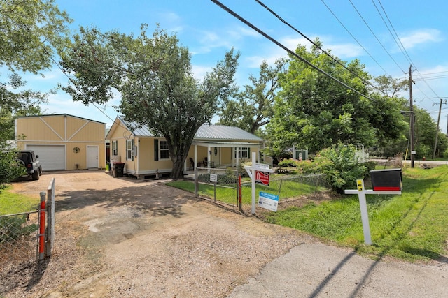 639 Manor St, Houston, TX 77015 - view of front of home featuring a fenced front yard, dirt driveway, a gate, and a garage