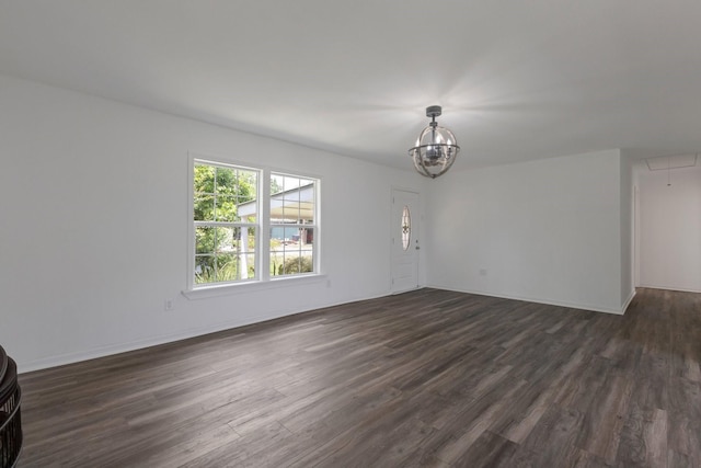 639 Manor St, Houston, TX 77015 - unfurnished living room featuring dark wood finished floors, attic access, a chandelier, and baseboards