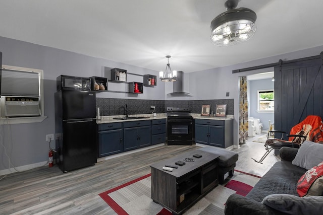 639 Manor St, Houston, TX 77015 - living area featuring a chandelier, light wood-type flooring, cooling unit, and a barn door