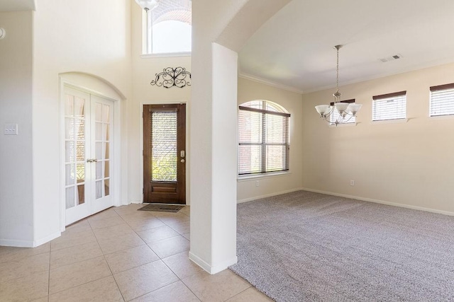 13907 Falling Rain Ct, Cypress, TX 77429 - entryway featuring a chandelier, baseboards, ornamental molding, and light tile patterned floors