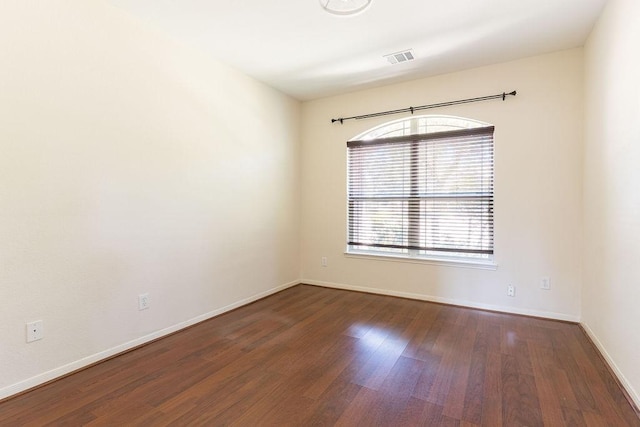 unfurnished room featuring wood finished floors and baseboards