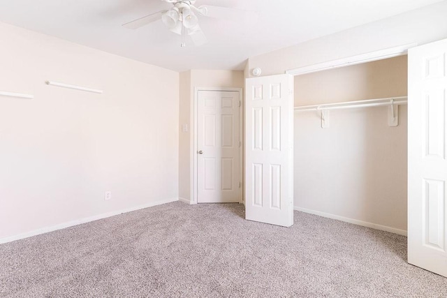 unfurnished bedroom featuring carpet flooring, a closet, baseboards, and a ceiling fan