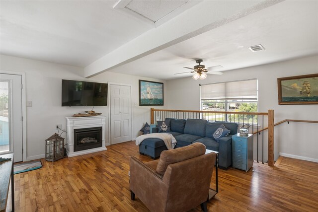 1619 Fm 517th Rd E, San Leon, TX 77539 - living room featuring plenty of natural light, wood finished floors, baseboards, beamed ceiling, and a ceiling fan