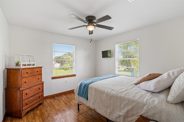 1619 Fm 517th Rd E, San Leon, TX 77539 - bedroom with multiple windows, wood-type flooring, baseboards, and ceiling fan