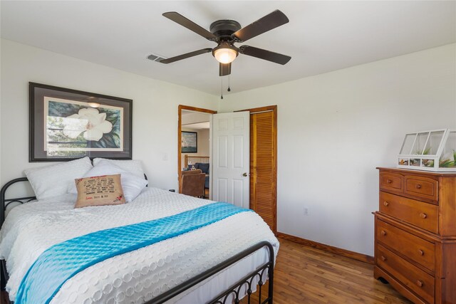 1619 Fm 517th Rd E, San Leon, TX 77539 - bedroom with wood finished floors, a closet, baseboards, and a ceiling fan