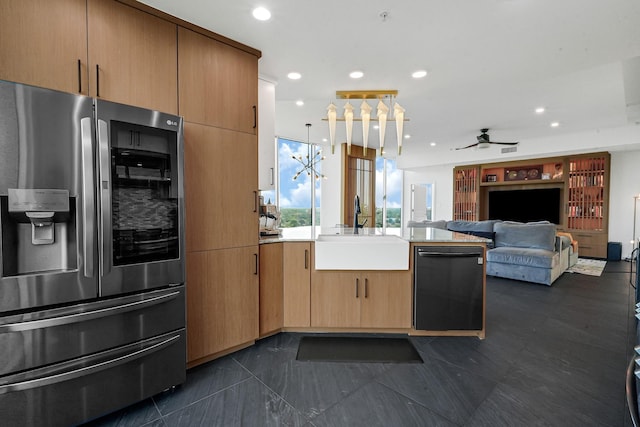 kitchen with stainless steel fridge, black dishwasher, a sink, a peninsula, and a ceiling fan
