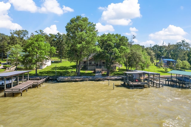 180 Hummel Ln, Coldspring, TX 77331 - dock featuring boat lift, view of scattered trees, and a water view