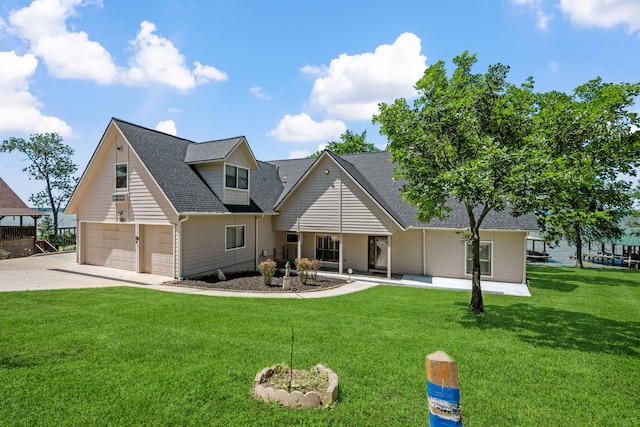 180 Hummel Ln, Coldspring, TX 77331 - view of front of property featuring a front yard, roof with shingles, driveway, and a garage
