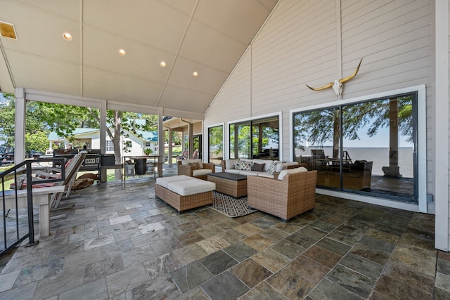 180 Hummel Ln, Coldspring, TX 77331 - sunroom / solarium featuring high vaulted ceiling, healthy amount of natural light, stone tile floors, recessed lighting, and wooden walls