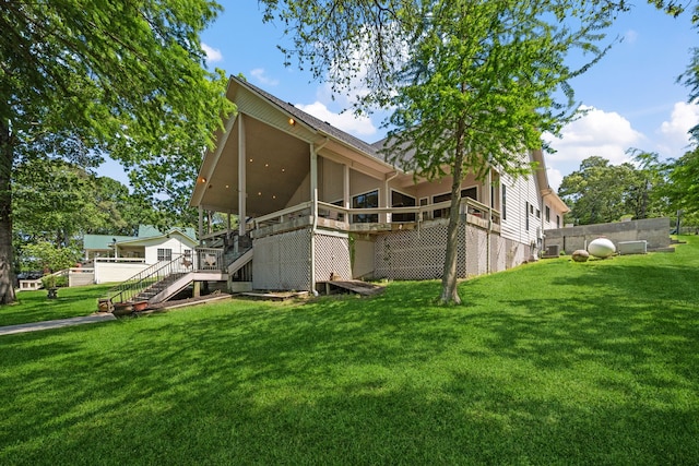180 Hummel Ln, Coldspring, TX 77331 - back of house with stairs, a lawn, a sunroom, and a deck