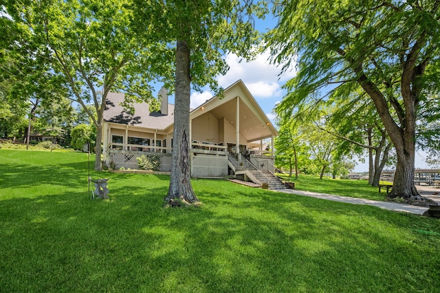 180 Hummel Ln, Coldspring, TX 77331 - back of house featuring a yard, stairs, and a chimney