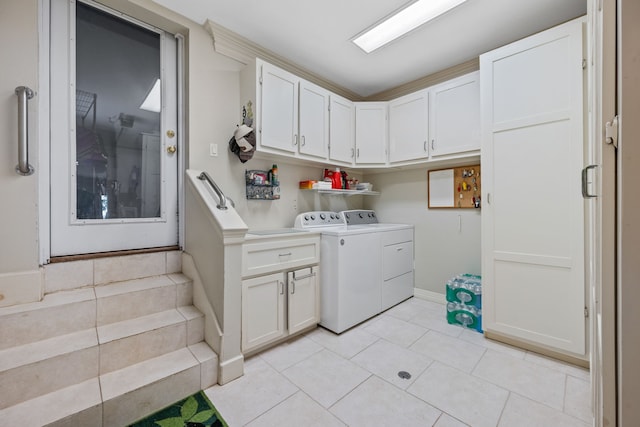 180 Hummel Ln, Coldspring, TX 77331 - washroom featuring washer and dryer, cabinet space, light tile patterned floors, and baseboards