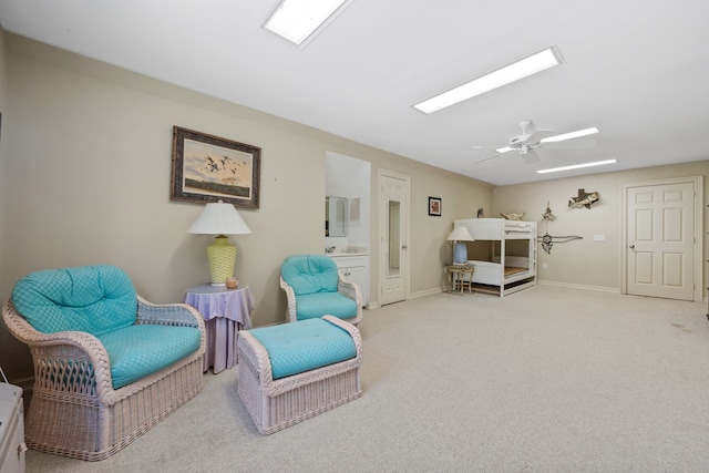 180 Hummel Ln, Coldspring, TX 77331 - living area with carpet floors, ceiling fan, a skylight, and baseboards