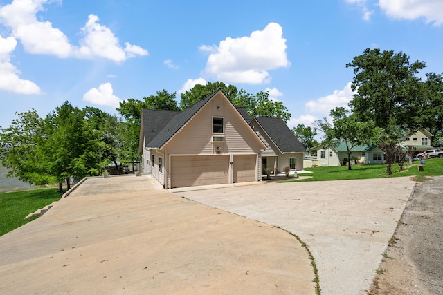 180 Hummel Ln, Coldspring, TX 77331 - view of side of property with driveway, a garage, and a lawn